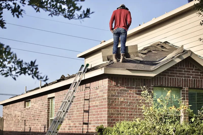 Professional roofer working on a residential roof in Savage